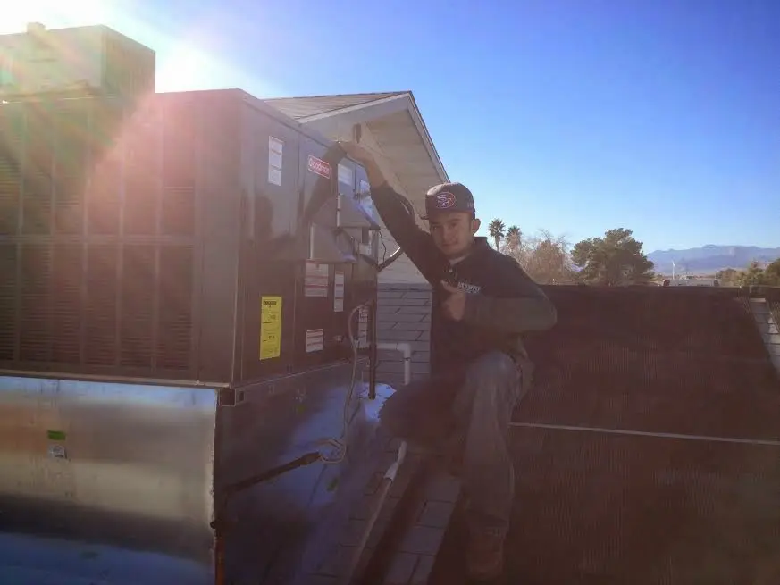 HVAC technician performing HVAC Inspection on a rooftop unit in Perrysburg